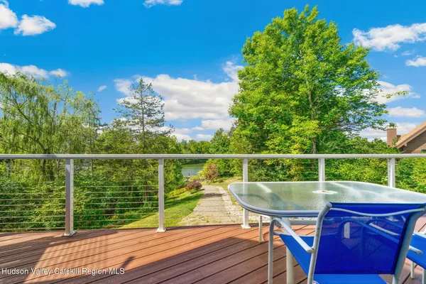 a view of a deck with wooden floor and outdoor seating