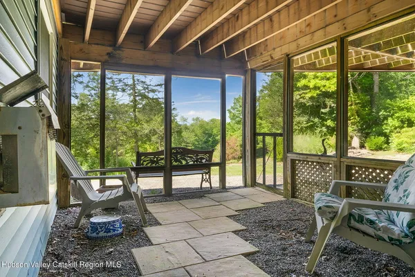a view of a deck with wooden floor and outdoor seating