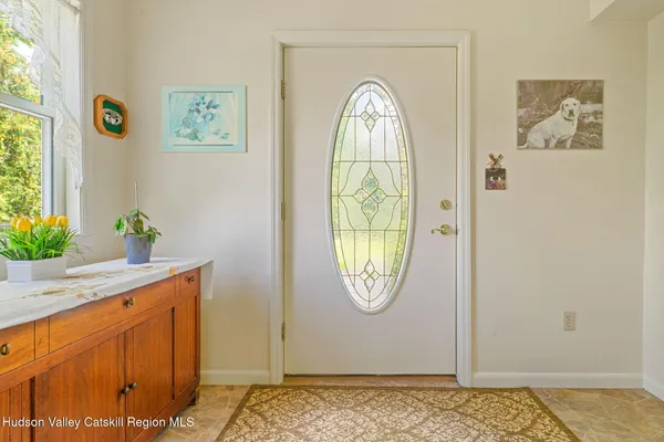 a view of a livingroom with wooden floor and a window