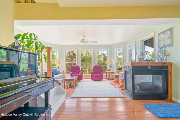 a living room with fireplace furniture and a wooden floor