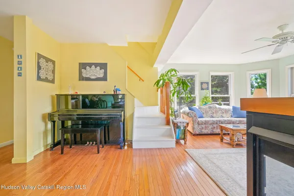 a view of a hallway with wooden floor and stairs
