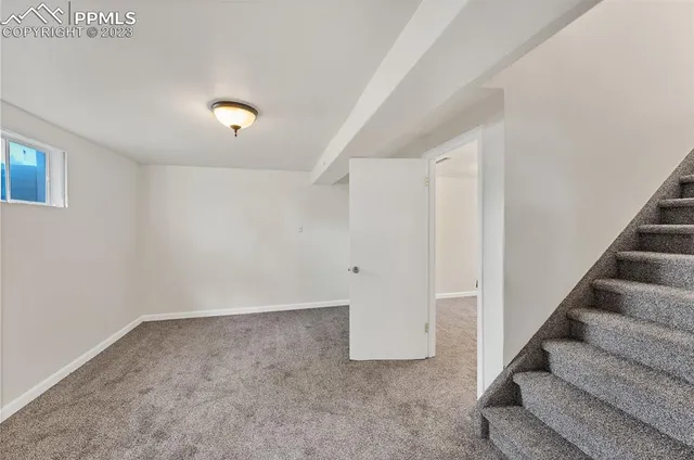 a view of an empty room with stairs