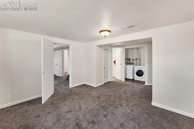 a view of a livingroom with wooden floor and a bathroom space