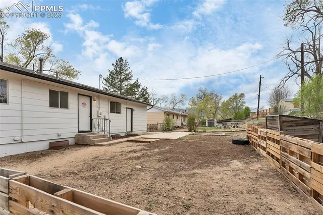 a view of a backyard with large trees