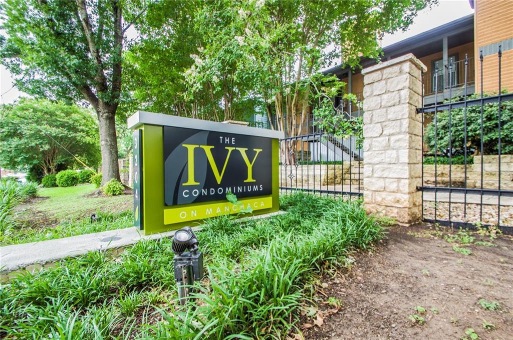 3204 Manchaca Road, Unit 302 Austin, TX 78704 - Photo 19 of 20 Mature trees shade the gated entrance stone pillar and monument signage.
