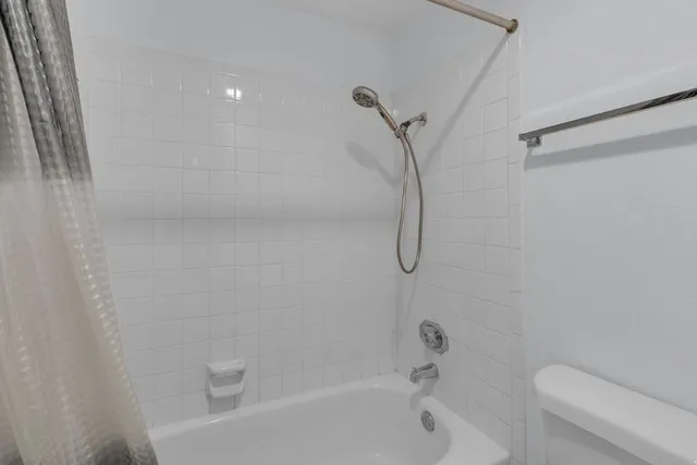 a bathroom with a shower and a toilet
