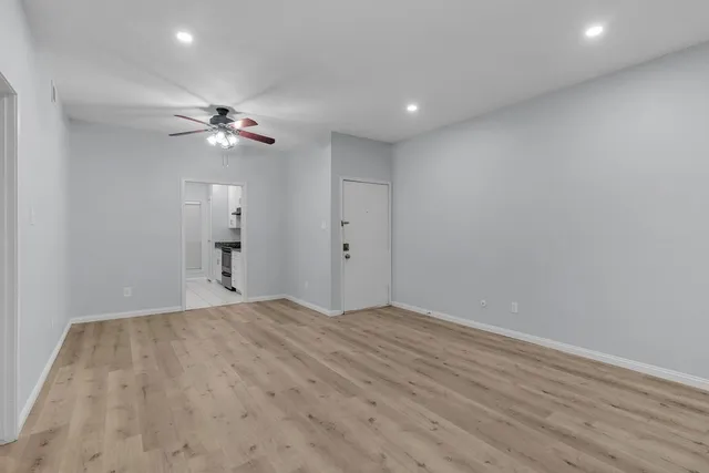 a view of empty room with a fan