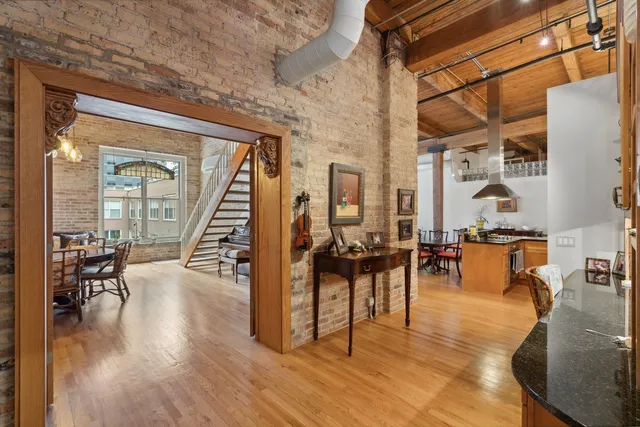 a living room with furniture a wooden floor and a chandelier
