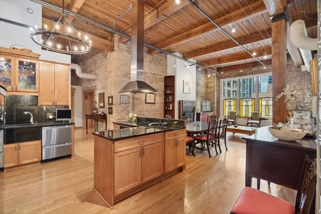 a kitchen with stainless steel appliances granite countertop a stove and cabinets