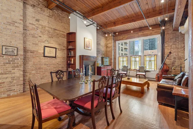 a dining room with furniture and wooden floor