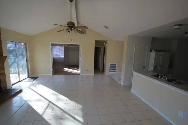 a view interior of a house with wooden floor and a chandelier fan