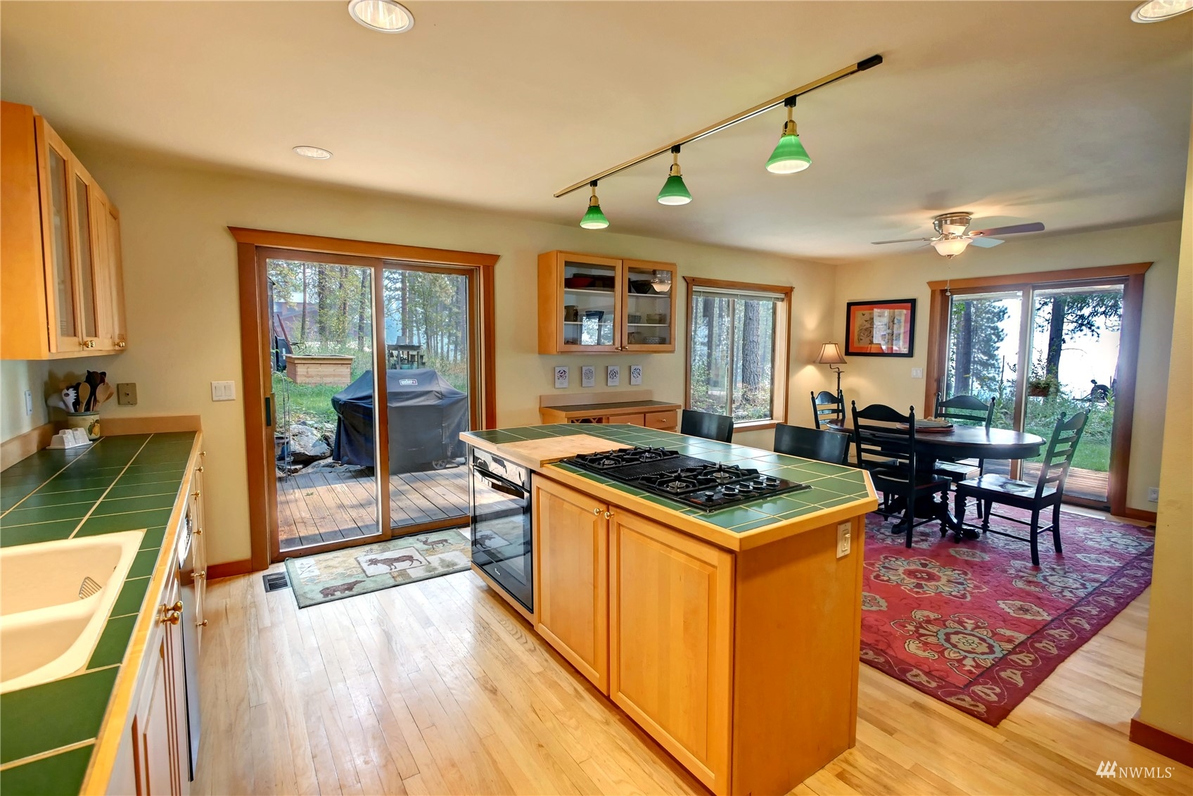 12 Bitterbrush Road Winthrop, WA 98862 - Photo 15 of 39 a kitchen with granite countertop a stove top oven a sink dishwasher a dining table and chairs with wooden floor
