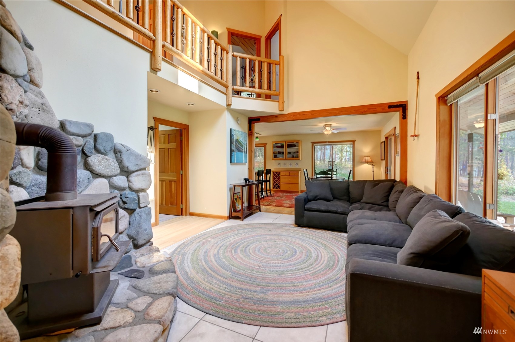 12 Bitterbrush Road Winthrop, WA 98862 - Photo 3 of 39 a living room with furniture a fireplace and a large window