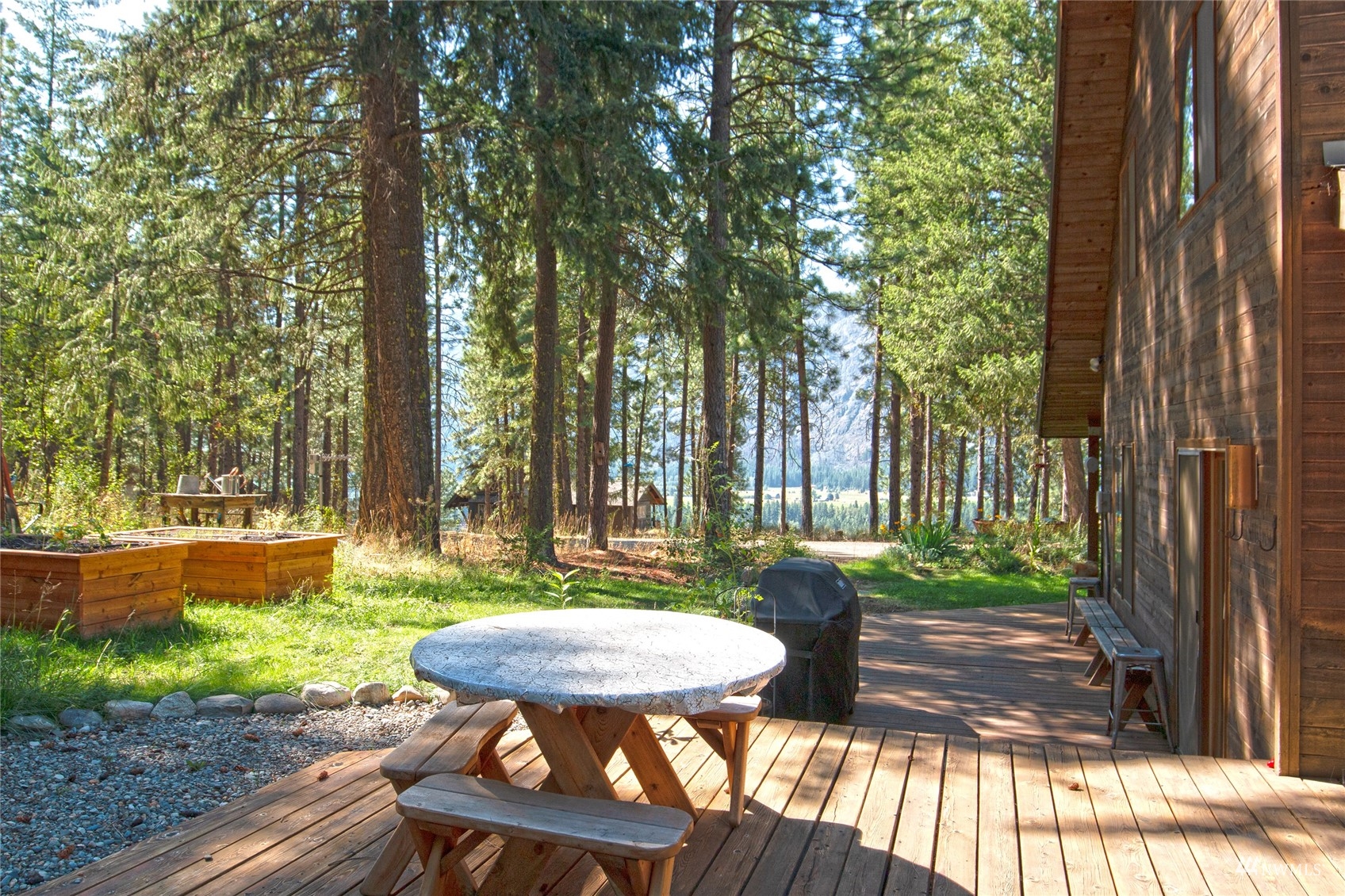 12 Bitterbrush Road Winthrop, WA 98862 - Photo 35 of 39 a view of a backyard with table and chairs potted plants and large tree