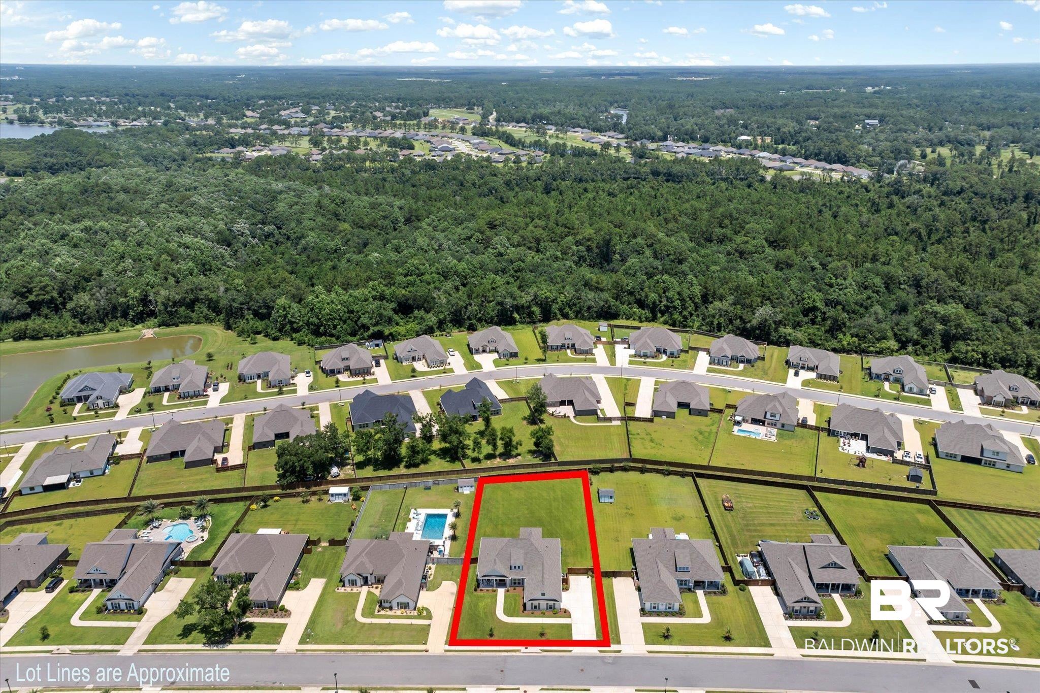 23523 Travis Stock Street Foley, AL 36535 - Photo 35 of 45 Aerial perspective highlighting a residential property with a manicured lawn