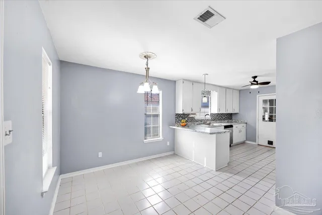 a kitchen with stainless steel appliances kitchen island granite countertop a sink and cabinets