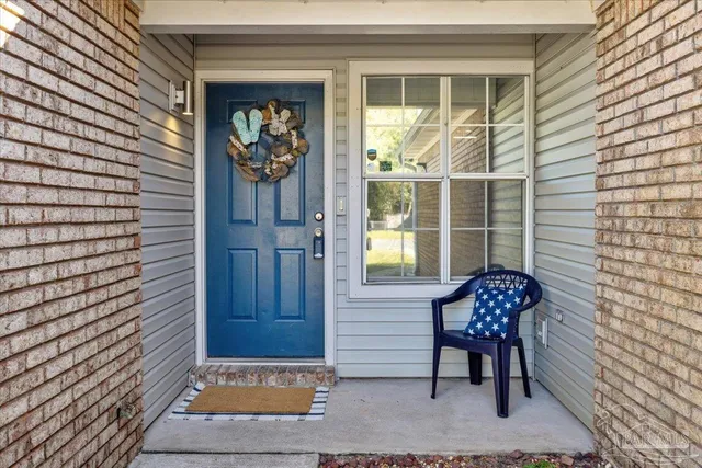 a view of a door with a bench and a door