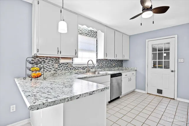 a kitchen with granite countertop a sink and a stove