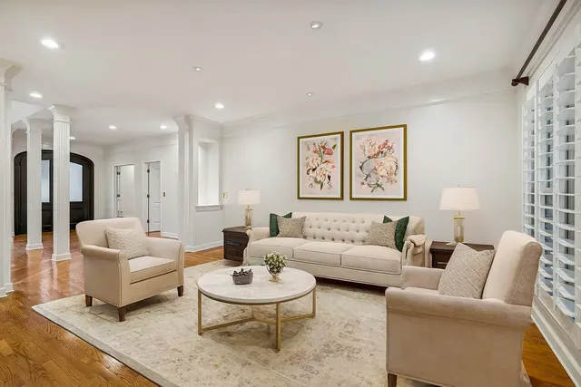 a living room with furniture and a view of kitchen