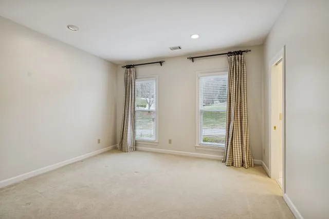 a bathroom with a granite countertop toilet sink and mirror