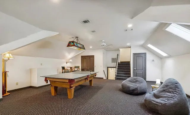 a living room with furniture a table and kitchen view