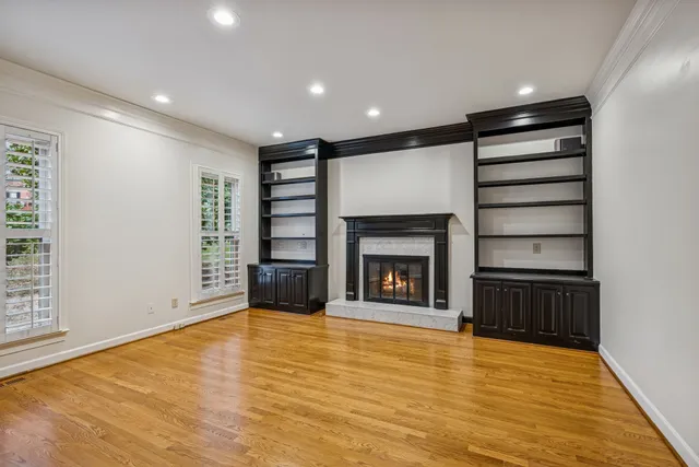 a view of an empty room with a fireplace and a window