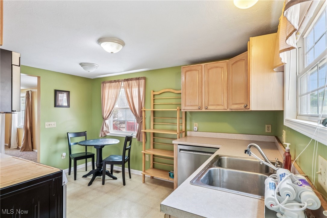 23 Lane Street Rittman, OH 44270 - Photo 20 of 34 Kitchen with light floors, light brown cabinetry, and dishwasher