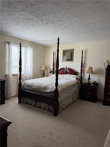 a bedroom with bed and window