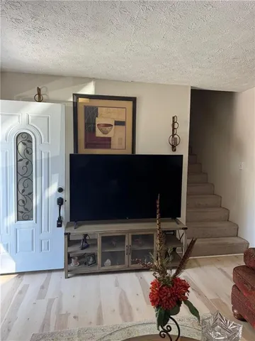 a view of living room with furniture and a flat screen tv