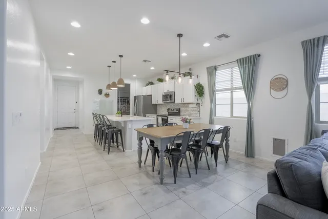 a large dining space with furniture and a large window