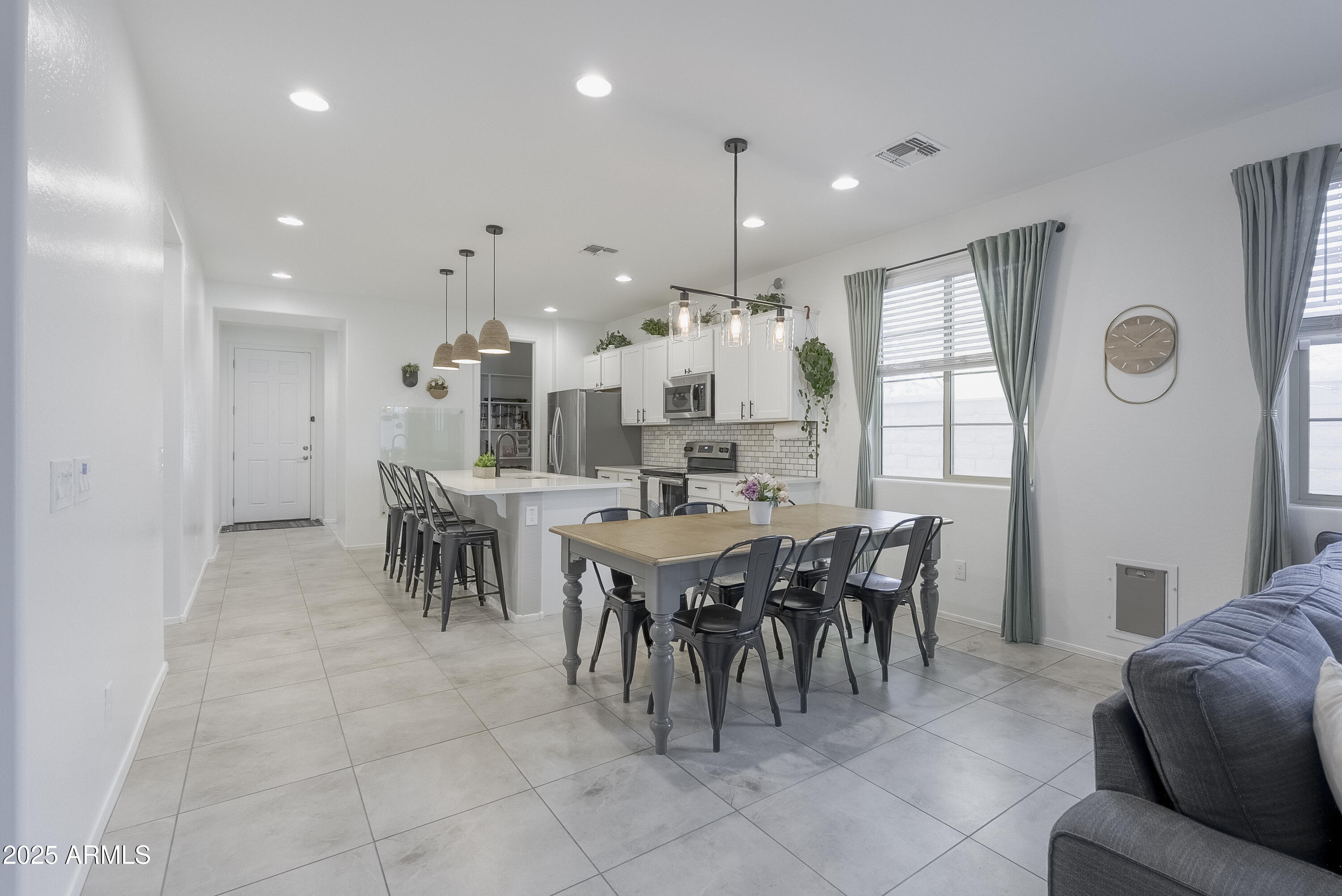 22638 East Quintero Court Queen Creek, AZ 85142 - Photo 14 of 39 a large dining space with furniture and a large window
