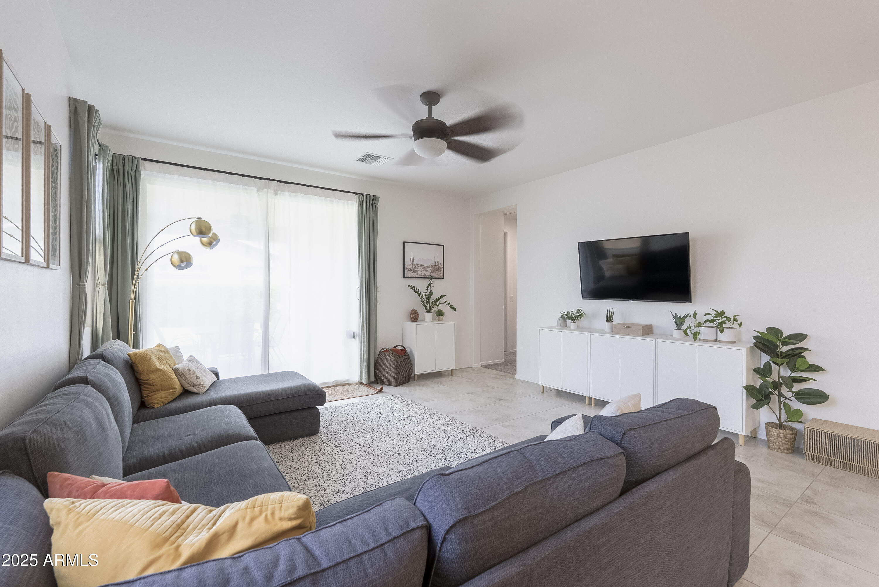 22638 East Quintero Court Queen Creek, AZ 85142 - Photo 15 of 39 a living room with furniture and a flat screen tv