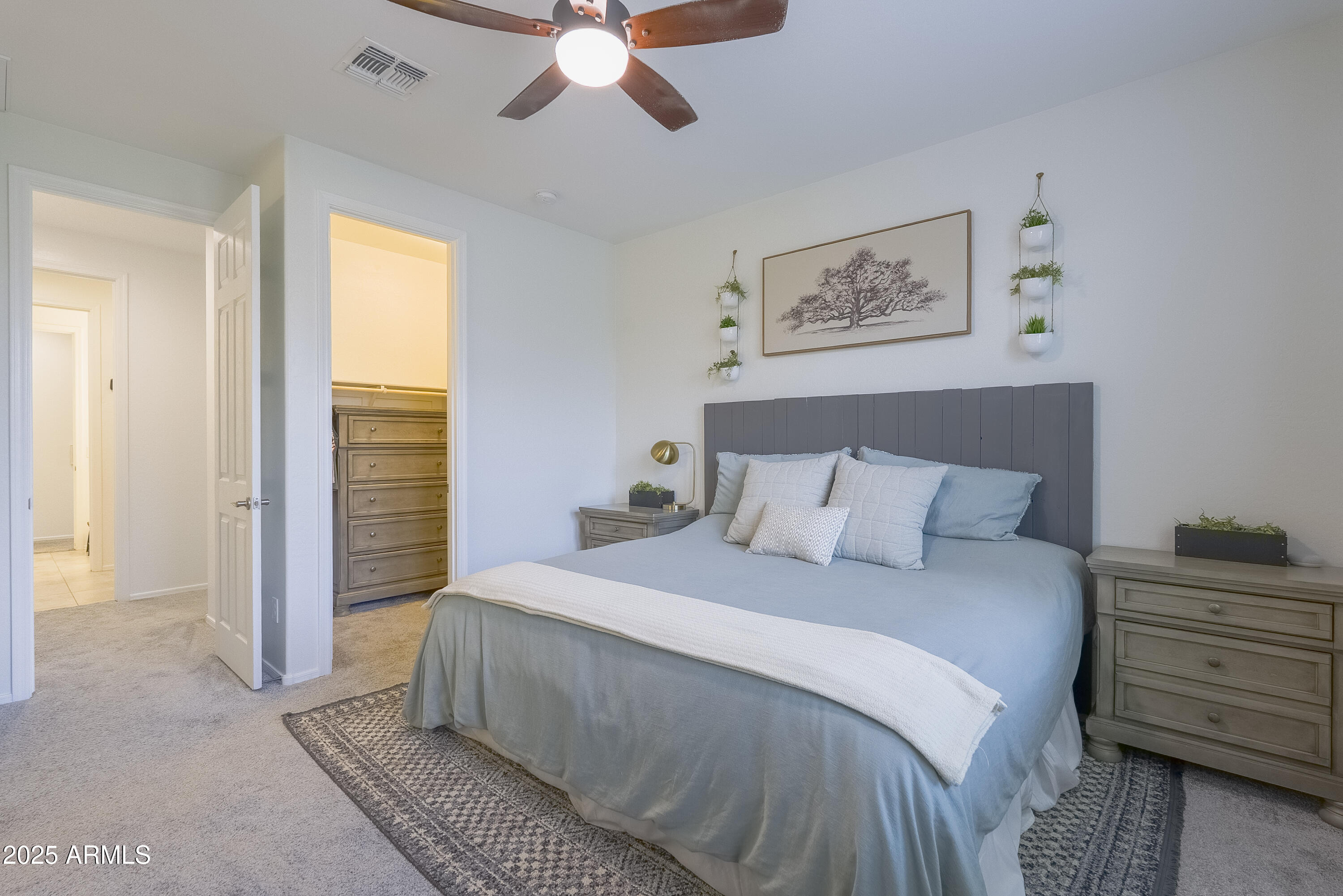 22638 East Quintero Court Queen Creek, AZ 85142 - Photo 18 of 39 a bedroom with a bed and a chandelier