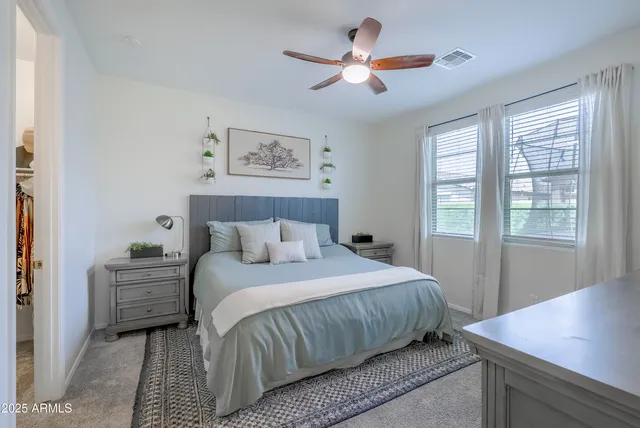 a bedroom with a large bed and a window