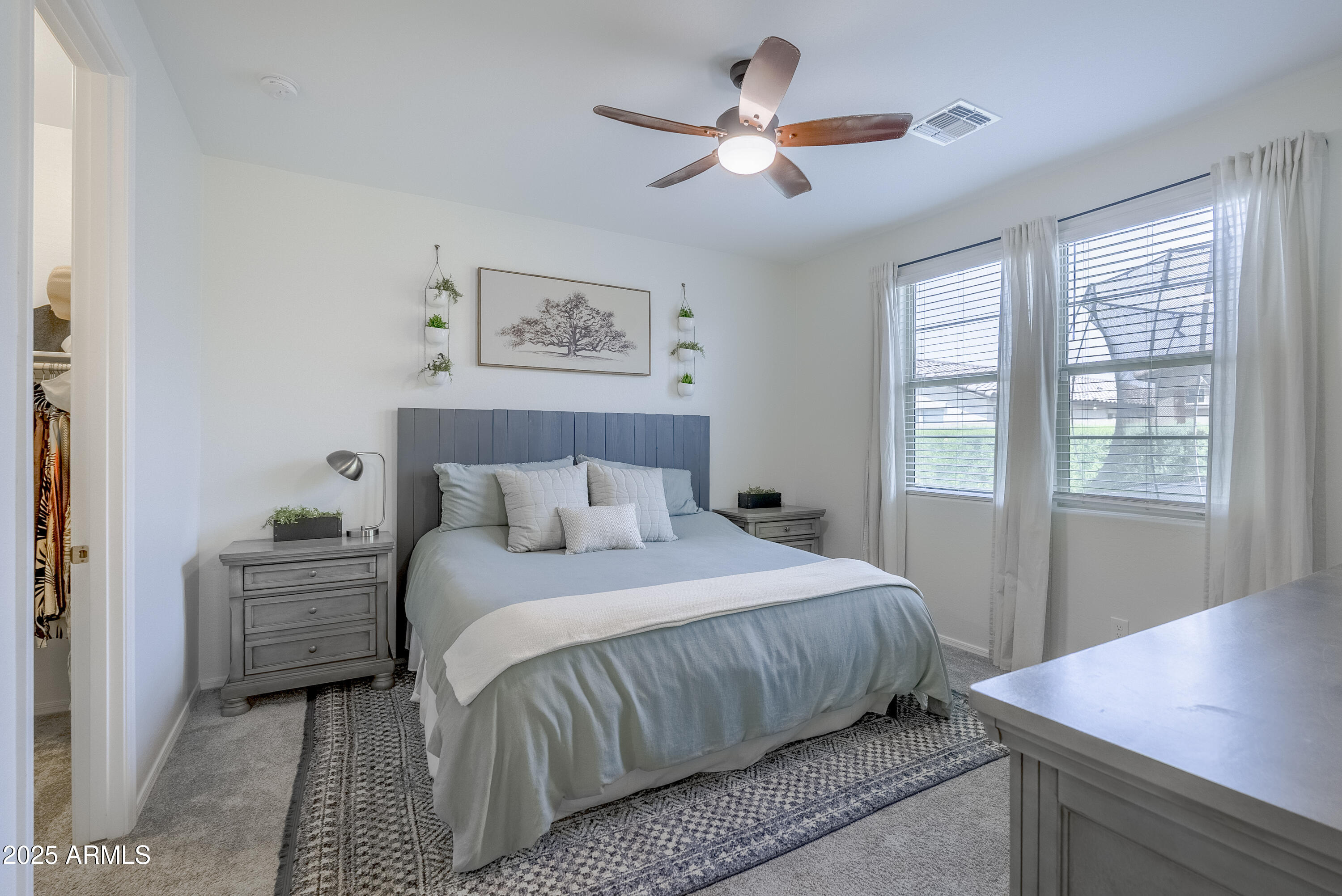 22638 East Quintero Court Queen Creek, AZ 85142 - Photo 19 of 39 a bedroom with a large bed and a window