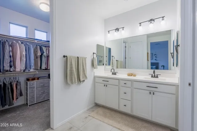 a bathroom with a double vanity sink and mirror