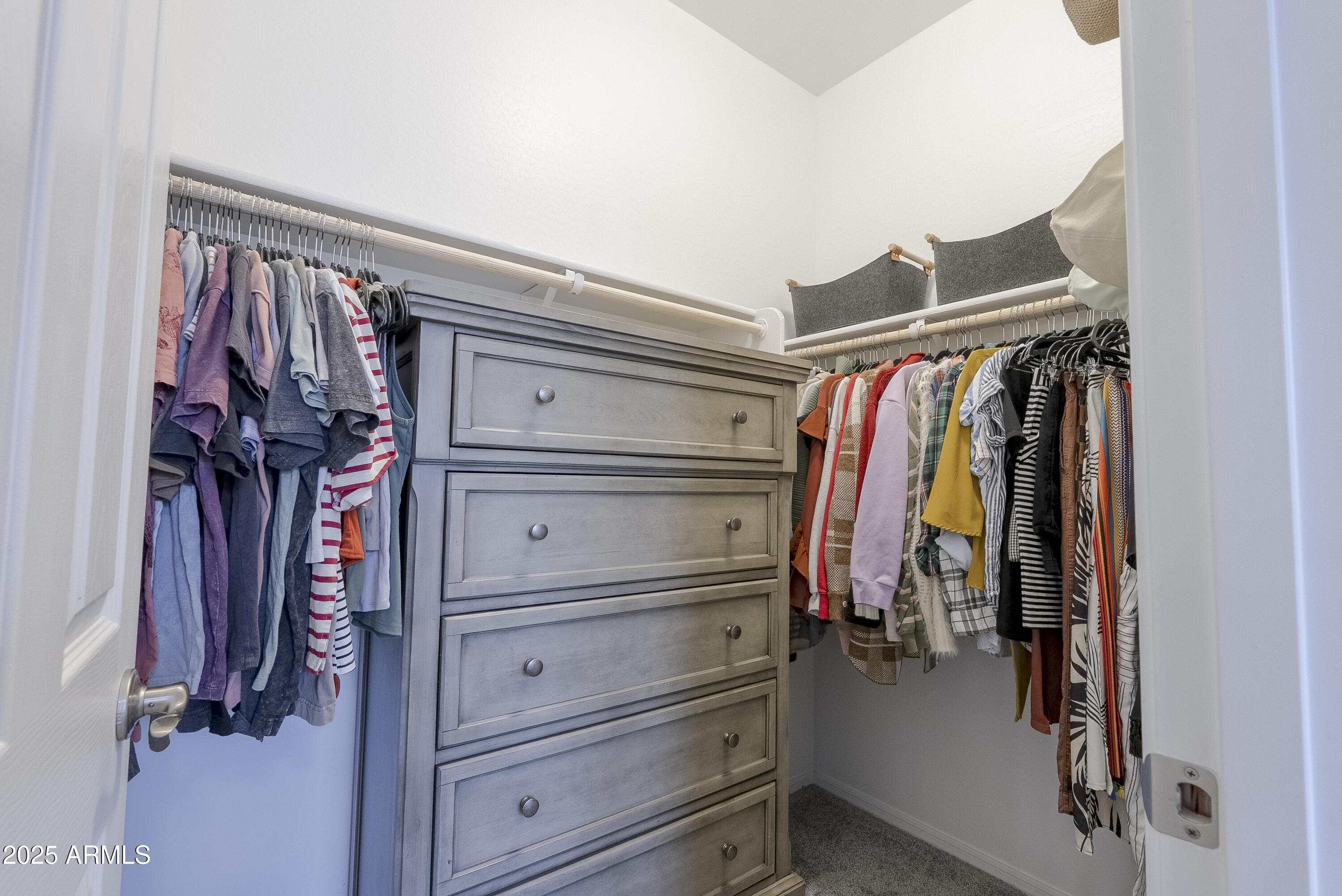 22638 East Quintero Court Queen Creek, AZ 85142 - Photo 24 of 39 a view of walk in closet with clothes and shoes