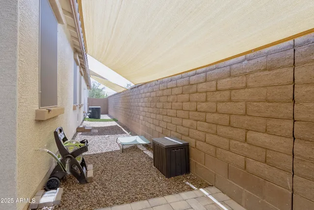 a backyard of a house with table and chairs