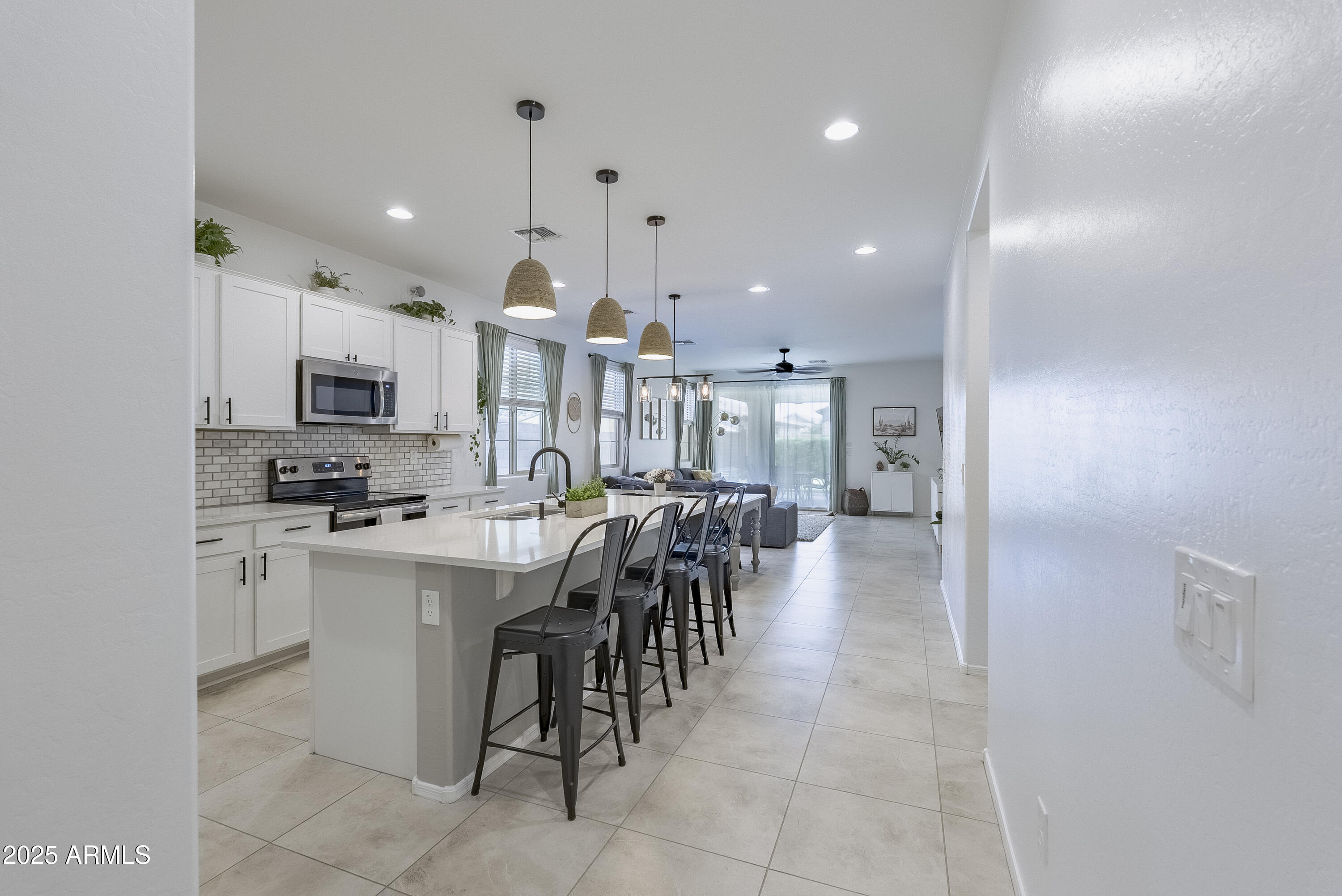 22638 East Quintero Court Queen Creek, AZ 85142 - Photo 6 of 39 a kitchen with cabinets and chairs