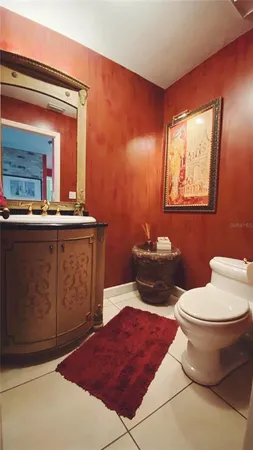 a bathroom with a toilet a sink and mirror