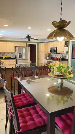 a kitchen with stainless steel appliances granite countertop a sink and a white cabinets