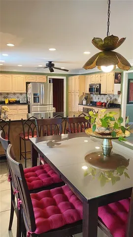 a kitchen with stainless steel appliances granite countertop a sink and a white cabinets