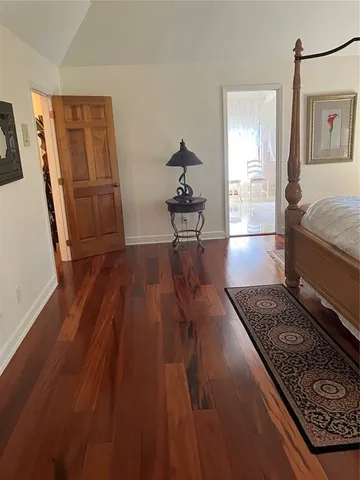 a living room with hard wood floors and a rug