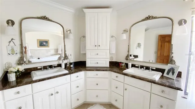 a bathroom with double sink and a mirror