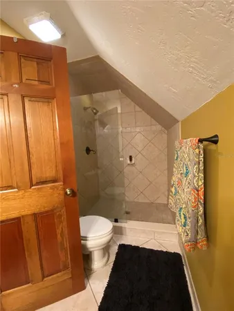 a bathroom with a shower and a toilet