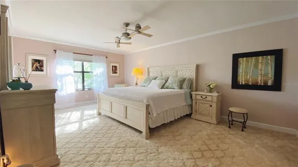 a bedroom with a bed and a chandelier