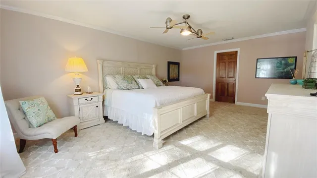 a bedroom with a bed a couch and a flat screen tv