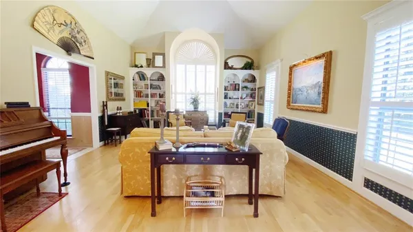 a living room with furniture and wooden floor