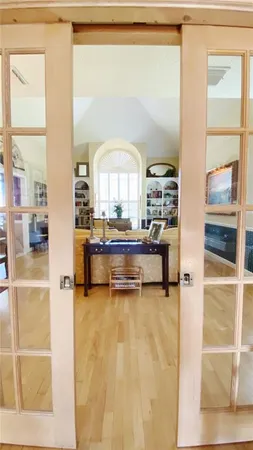 a living room with a large window and a wooden floor
