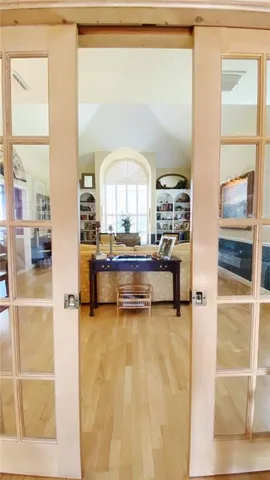 a living room with a large window and a wooden floor
